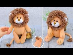 a stuffed animal lion sitting on top of a wooden floor next to a person's hand