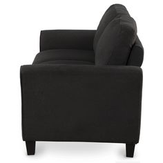 a black couch sitting on top of a white floor