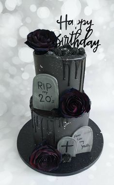 a three tiered cake decorated with purple roses and tombstones for a happy birthday