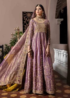 Purple Colored Pakistani Bridal Pishwas Frock Dupatta is a traditional masterpiece to have a breathtaking appearance on the big day. Lavish work of dabka and resham make this stunning Pakistani Bridal Dress your foremost priority to have a dreamy elegant look for the wedding. Pishwas: Pishwas Frock in an alluring purple sade is emblazoned with classic embroidery work. Threads, tilla, and floral designs enhance the glamour and traditional look of this beautiful Pakistani Bridal Pishwas. The Pishw Bridal Pishwas, Pakistani Bridal Dress, Classic Embroidery, Walima Dress, Desi Dress, Nikkah Dress, Frock Style, Pakistani Wedding Outfits, Pakistani Fashion Party Wear