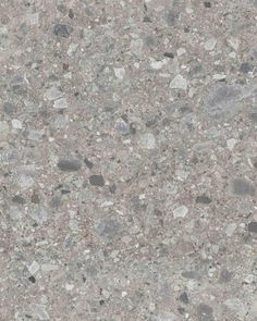 a close up view of the surface of a concrete floor with small rocks and gravel