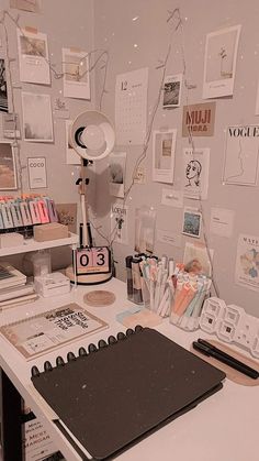 the desk is cluttered with papers, pens and other office supplies including a lamp