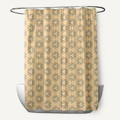 a shower curtain hanging on the side of a bathtub in front of a white wall