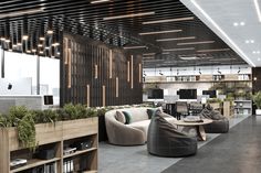 an office lobby with couches, tables and bookshelves