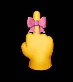 a yellow hand with a pink bow on it