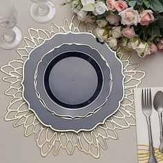 there is a place setting with silverware on the table and flowers in the background