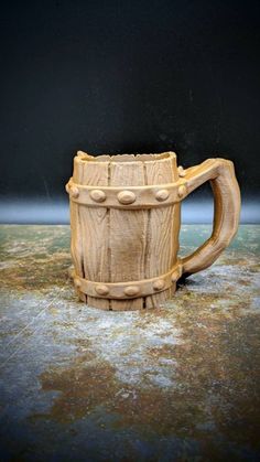 a wooden mug sitting on top of a table