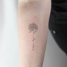 a woman's arm with a flower tattoo on it that reads, i love you