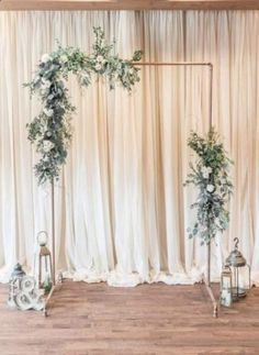 a wedding ceremony setup with white flowers and greenery