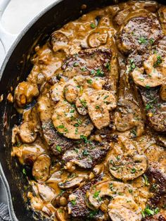 pork chops with mushroom gravy in a skillet