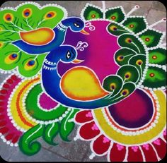 a colorful painting on the ground with peacocks