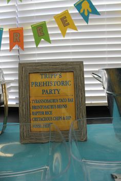 there is a sign on the table that says trip's prehistoriic party