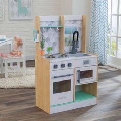 a child's play kitchen with an oven and stove