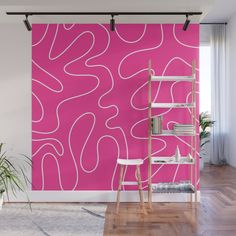 a pink wall with white lines on it and a ladder in front of the wall