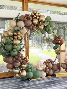 a wreath made out of fruits and vegetables sitting on a window sill in front of a large window