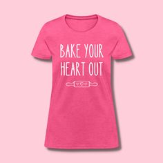 a pink shirt that says bake your heart out