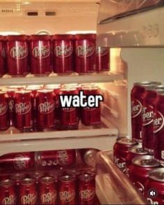 a refrigerator filled with lots of red soda