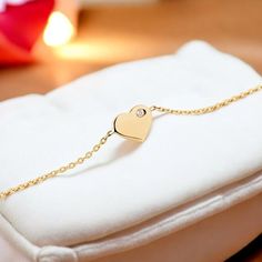 This elegant and stylish 14K gold bracelet is a must-have addition to any woman's jewelry collection. The minimalist heart detail at the center symbolizes love and grace, making it a standout piece. The heart is adorned with a sparkling diamond, adding a touch of sophistication to the design. With the option to personalize with a birthstone, this bracelet makes a meaningful gift for special occasions or everyday wear. It's the perfect present for mothers, wives, or loved ones on Valentine's Day, Heart Diamond Bracelet, Gold Heart Bracelet, Bracelet Minimalist, Sparkling Diamond, Wedding Jewelry Bracelets, Delicate Design, Wedding Bracelet, Gold Heart, Dainty Jewelry