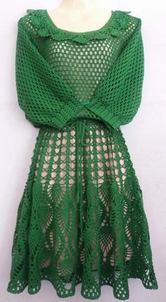 a green dress on a mannequin dummy with an open back and crochet