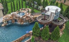 an aerial view of a home with a pool and slide in the middle of it