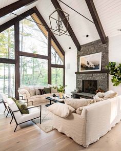 a living room filled with furniture and a fire place in the middle of a room