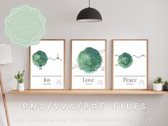 three green watercolor prints on a shelf with the words love and peace above them