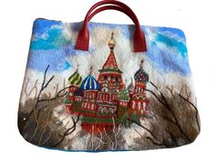 The background of the handbag is handmade by felted wool and silk fibres. On the back side,  the handbag has an abstract design. On the face side, the handbag has as embellishment a needle felted image,  of the St. Basil Cathedral from Moscow. The handbag has handles made by natural leather. Inside the handbag has a silky padded lining and two pockets. The size is 46 cm width on 32 cm hight. The handles are short and cannot be taken over the shoulders. Rectangular Felt Travel Bag, Handmade Felt Bag For Daily Use, Rectangular Felt Bags As Gifts, Rectangular Felt Bags For Gifts, Felted Handbags, Felted Wool, Needle Felted, Natural Leather, Needle Felting