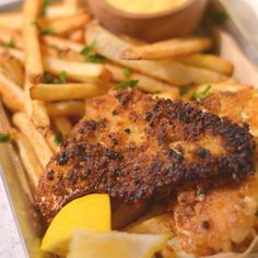 a tray with some chicken and french fries on it