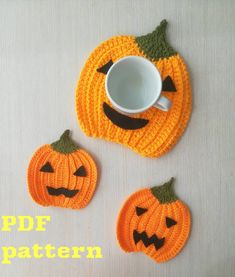 two crocheted pumpkin coasters and a coffee cup cozying pattern for halloween