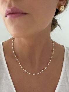 "D E T A I L S - 18K Gold Filled, Freshwater Pearls Synthetic - 16\" length with a 2\" extender - Lobster Clasp  M A T E R I A L S At Dylan Rae, we are committed to handcrafting jewelry that is perfect for everyday wear. Our high-quality gold filled designs contain 100+ times more real gold than gold plated components. The thick outer layer of gold makes it highly durable and safe for people with allergies or sensitive skin. C A R E Care for Your Gold Filled Jewelry: Wear It, Love It, Care for It! Our gold-filled pieces are crafted to be your lifelong companions. Feel free to wear them every day, even while showering, but remember to avoid exposing them to saltwater and chlorine. These elements can diminish their luster over time and may even cause oxidation if they come in contact with yo Affordable 8mm Bead Pearl Necklace, Dainty Single Strand White Chain Necklace, Dainty White Adjustable Chain Necklace, Dainty White Single Strand Chain Necklace, White Dainty Beaded Necklace With Adjustable Chain, White Clavicle Chain Beaded Necklace For Wedding, Dainty White Beaded Necklace With Adjustable Chain, White Beaded Clavicle Chain Necklace For Wedding, White Beaded Wedding Necklaces