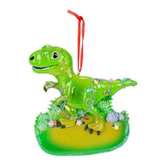 a green ornament shaped like a dinosaur