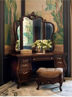 a dressing table with a mirror and stool