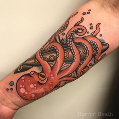 an octopus tattoo on the left arm