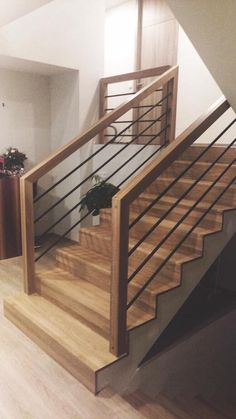 a wooden staircase with metal handrails in a home