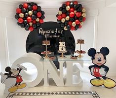 a mickey mouse themed birthday party with balloons