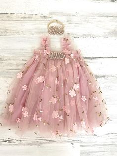 This listing if for a vintage pink  floral tutu dress!  Perfect for that 1st birthday!!  *This dress comes as is (with no "one")- "Dress only" option from the drop down menu Dress with one (just the one dress) One Dress with headband   ~headband elastic can be made in any color! ~ ships within 1 to 3 business days (message me with any additional questions)! ~ headband backed with felt for comfort {{SIZING}}  6-9 months (fits 18-20 lbs.) 9-12 months (fits 20-22 lbs.) 12-18  months  (fits 22-26 lb Pink Princess Dress For First Birthday In Spring, Whimsical Summer Tutu Dress For First Birthday, Spring Tulle Princess Dress For First Birthday, Spring First Birthday Tulle Princess Dress, Whimsical Pink Princess Dress With Floral Applique, Cute Fairy Dress For First Birthday In Spring, Spring Birthday Tulle Tutu Dress, Princess Tutu Dress With Floral Applique For Birthday, Princess Style Tutu Dress With Floral Applique For Birthday