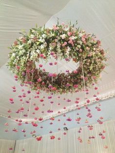 an arrangement of flowers hanging from the ceiling