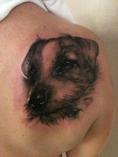 a dog tattoo on the back of a woman's stomach