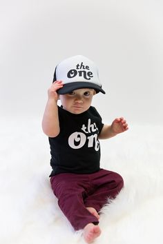 "Make your Little One's birthday extra special with our The One hat! Perfect for pictures and versatile enough to wear year round! This listing is for the hat only, but check out our other The One matching Tshirts in the \"One/ Uno Birthday\" section in our shop. Care Instructions: Spot clean only with damp cloth. This listing is for the romper only, but... We also carry accessories and mom, dad , and sibling shirts all available in the \"One Birthday\" section of our shop. You can find that her White Letter Print Hat For Birthday, Personalized White Trucker Hat For Birthday, Adjustable Black Mini Hat For Birthday, Birthday Snap, Baby Boy Birthday Outfit, Uno Birthday, Birthday Minimalist, Knit Crown, First Birthday Crown