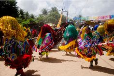 people in colorful costumes are walking down the street