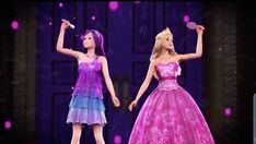 two barbie dolls dressed in pink, blue and purple gowns on stage with lights behind them