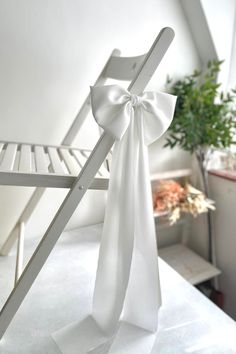 a white chair with a bow on it