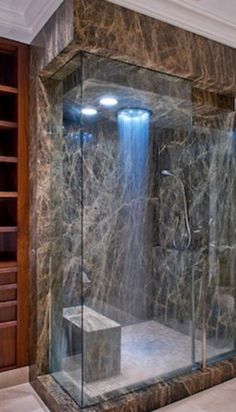 a walk in shower sitting inside of a bathroom