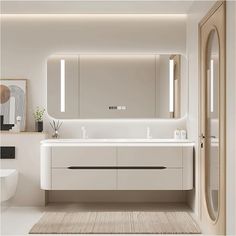 a bathroom with a large mirror above the sink and two sinks on either side of it