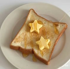 toast with butter and stars on it sitting on a plate