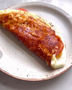 an omelet with cheese and tomatoes on a plate