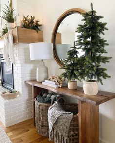 a living room with a christmas tree in the corner and a mirror on the wall