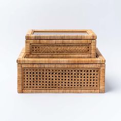 two wicker boxes sitting on top of each other