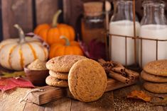 cookies, milk and pumpkins on a wooden table