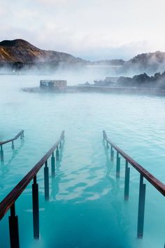 the water is very blue and there are wooden railings